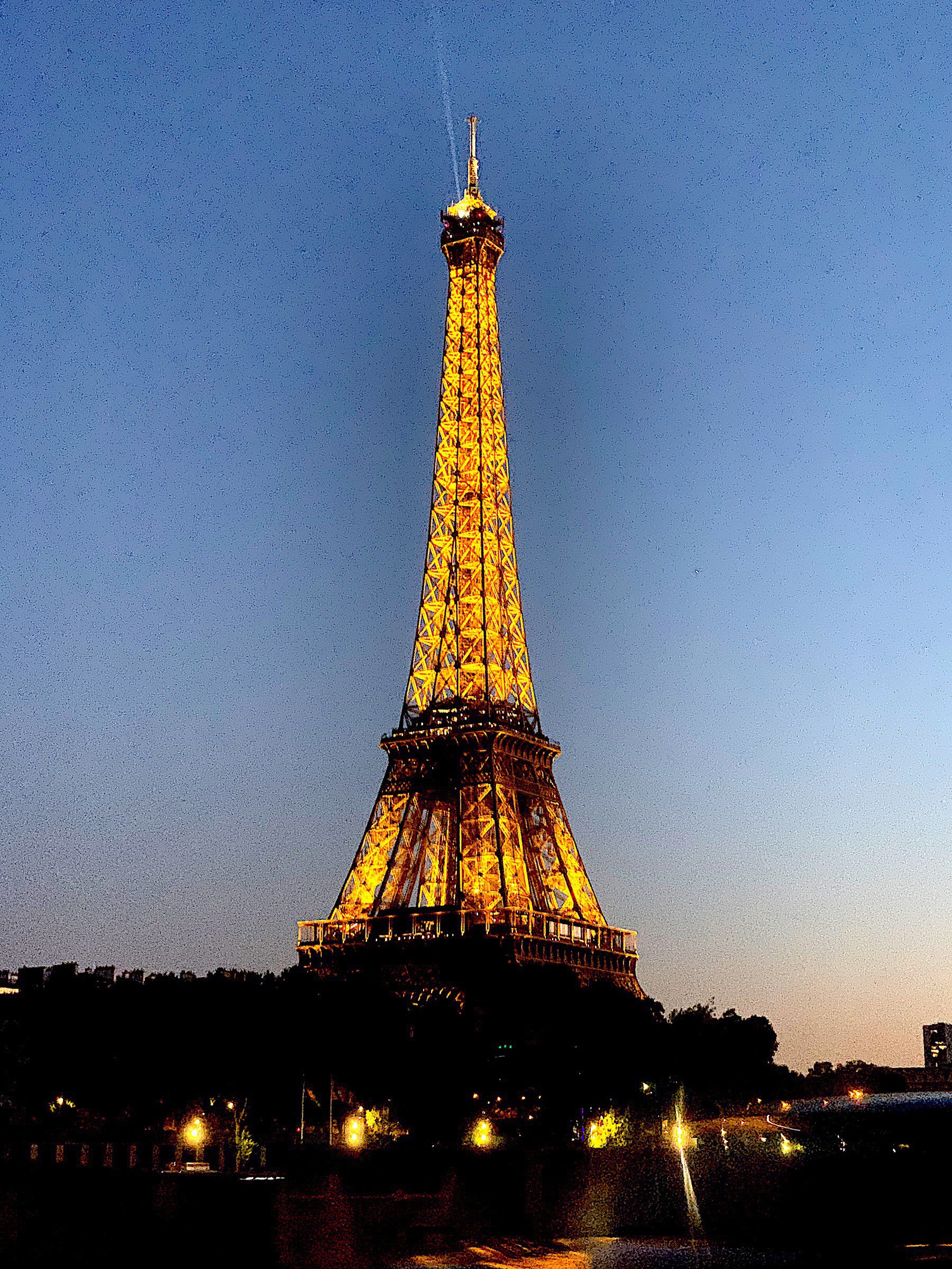 Eiffel Tower lit at dusk